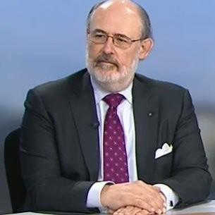 Former CIA Officer Ronald Marks, now a term visiting professor at the Schar School of Policy and Government, seated at a desk