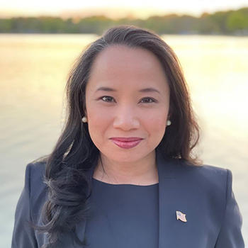 2015 Master’s in Public Policy alumna Camille Calimlim Touton in front of a body of water.